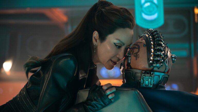 Michelle Yeoh in Star Trek: Section 31. Yeoh leans over a person with Borg-like implants. Sci-fi TV show.