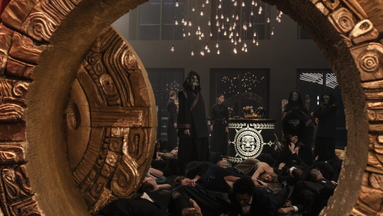 The Cleaner TV series scene. People in masks stand over bodies. Ornate stone frame.