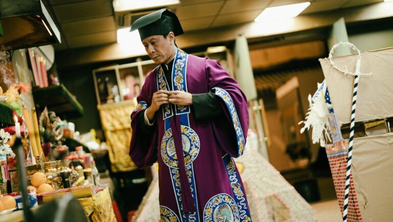 Man in traditional Chinese funeral attire. Asian culture, religious ceremony.