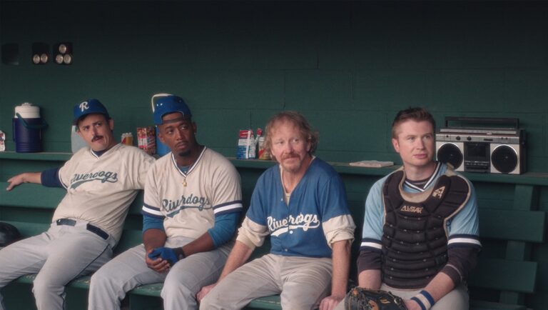 Eephus movie scene: Baseball team Riverdogs in dugout. Players in uniform, vintage boombox visible.