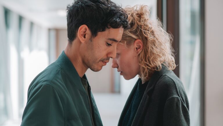 Ghost Trail movie scene. Man and woman close with heads together. Drama, film still.