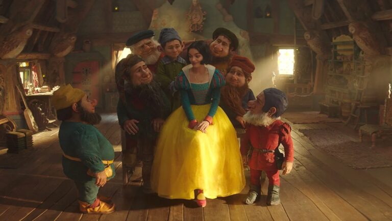 Disney's Snow White and the Seven Dwarfs. Snow White in her iconic dress surrounded by the seven dwarfs in their cottage.