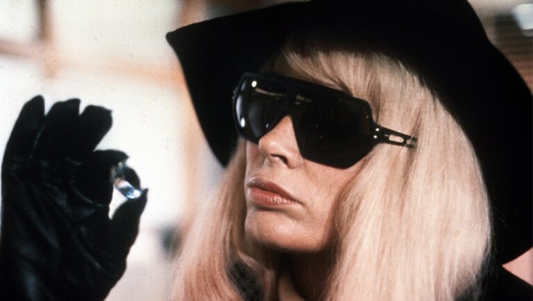 Barbara Harris in Hitchcock's Family Plot. Woman with blonde hair, sunglasses, hat, and gloves holds a diamond ring.