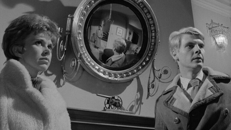 Black and white film still from Joseph Losey's The Servant featuring a woman and man in a tense scene.