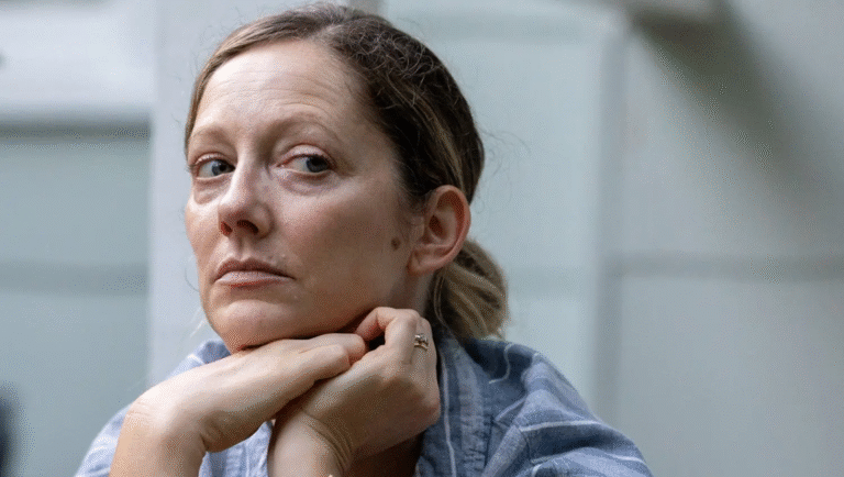 Dana Hawley as Magnolia. Woman with hands under chin, looking sideways. Serious expression. Magnolia movie.