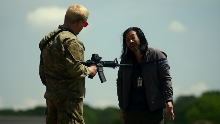 Nelson Lee as Tony in Civil War. Soldier points rifle at him. Alex Garland film.