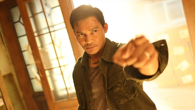 Striking Rescue movie still: Man in action pose, determined expression. Martial arts film scene.