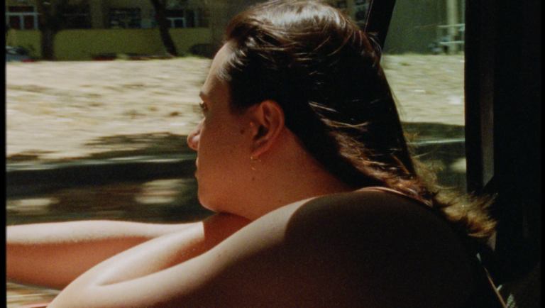 Still from Mad Bills to Pay, New Directors/New Films 2025. Person looking out car window.