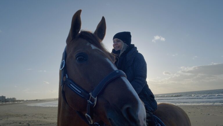 Woman riding a horse on a beach. Animal documentaries at CPH:DOX '25.