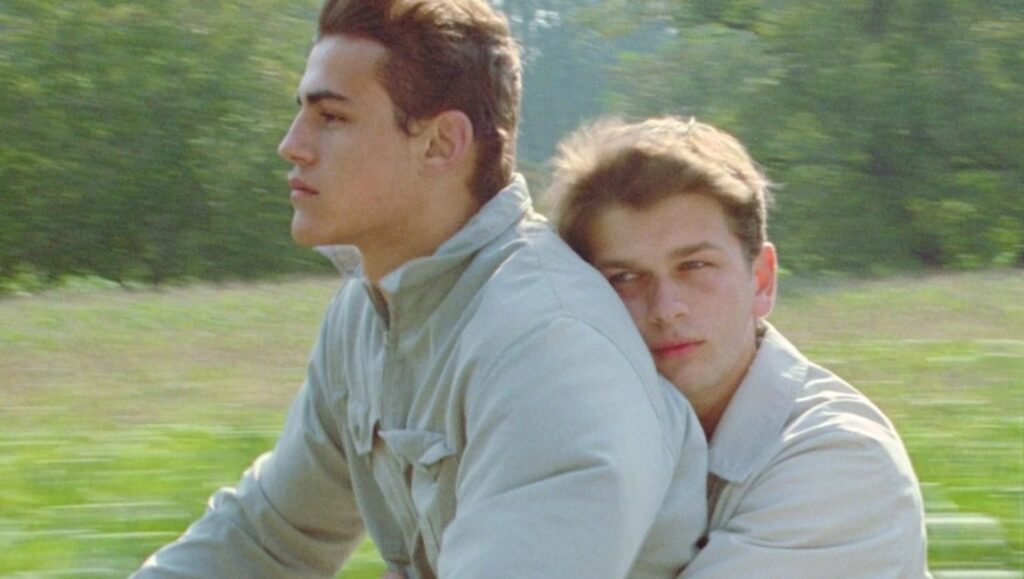 The Instinctual Lurches of Desire: André Téchiné’s Wild Reeds Two young men in André Téchiné's Wild Reeds embrace on a bike ride. Coming-of-age film.