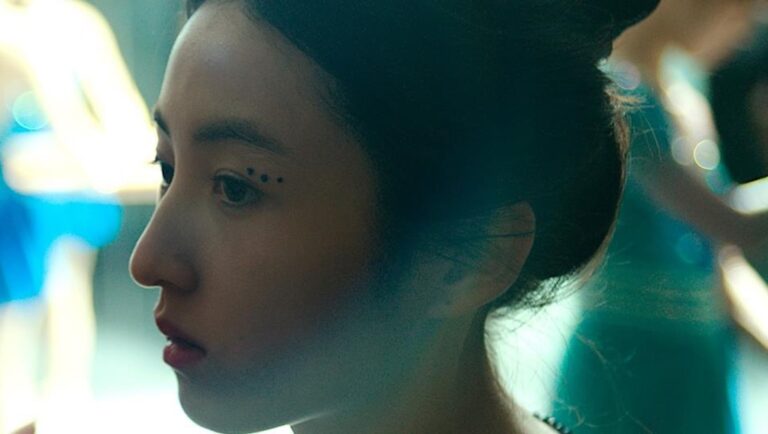 Profile of actress in Girl on the Edge at Cannes Film Festival. Dotted eye makeup detail.