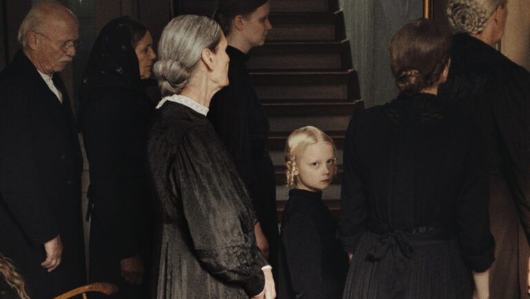 Mourning family in black attire. Somber group with a young girl. Funeral scene. Vintage style.