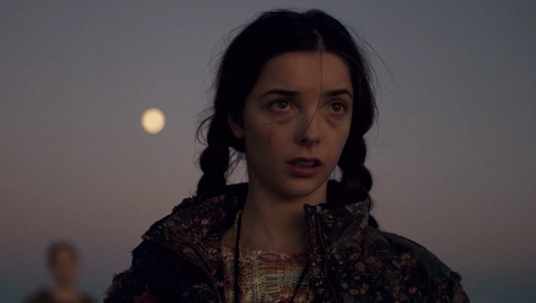 A young girl looking at something unseen, with a moon and a blurry person in the background.