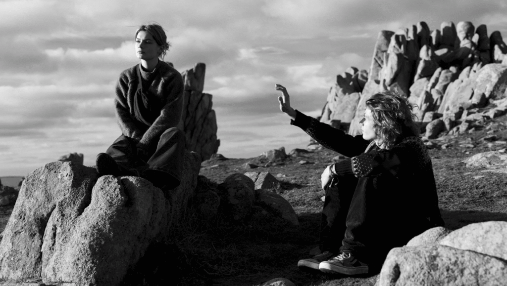 FIDMarseille 2025: Black and white shot of two people sitting on rocks in Morlaix, France.