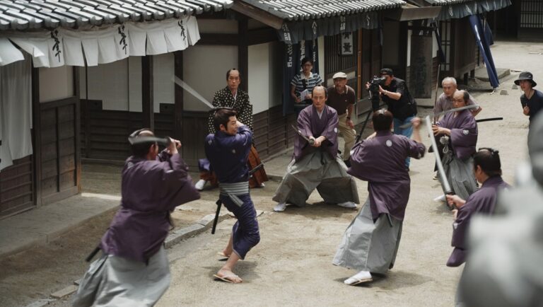 Japan Cuts 2025 film still: Samurai fight scene. Japanese swordsmen duel in traditional garb. Serpent's Path, Blazing Fists, Teki Cometh.