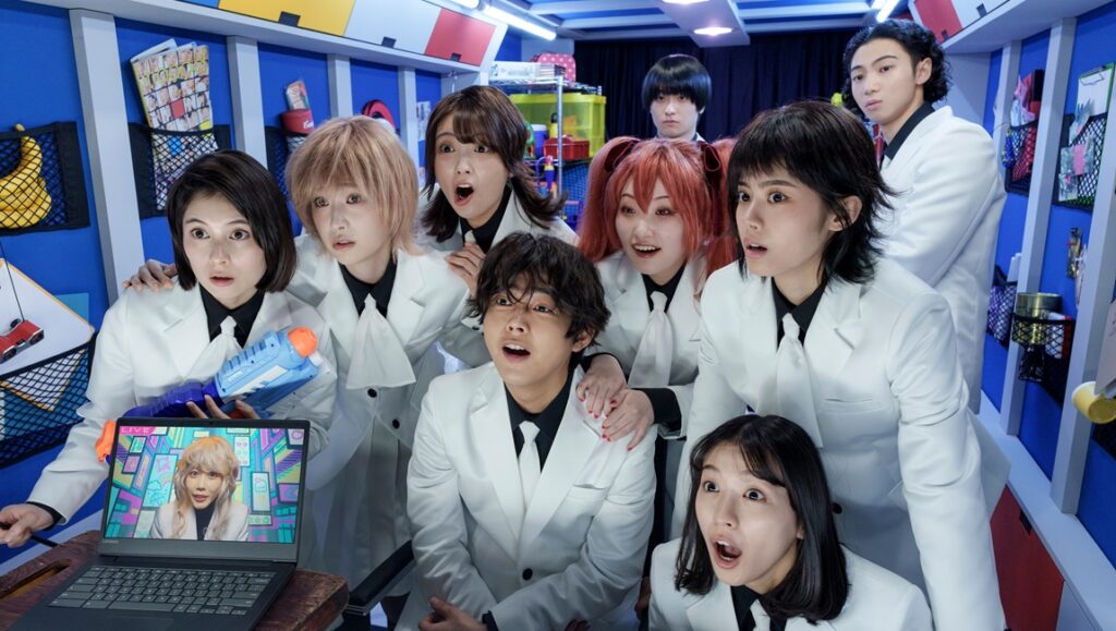 Honeko Akabane's Bodyguards cast reacts to a laptop screen. Actors in white suits show surprise. Japanese drama series.