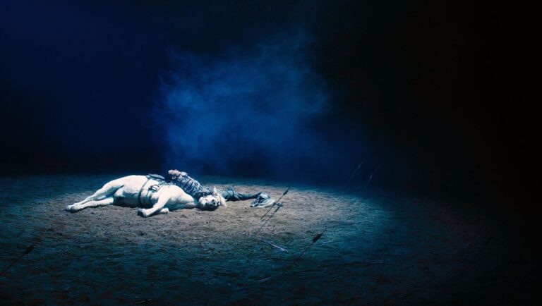 NYAFF 2025: To Kill a Mongolian Horse film still. A horse and rider lie on the ground, illuminated by a spotlight.