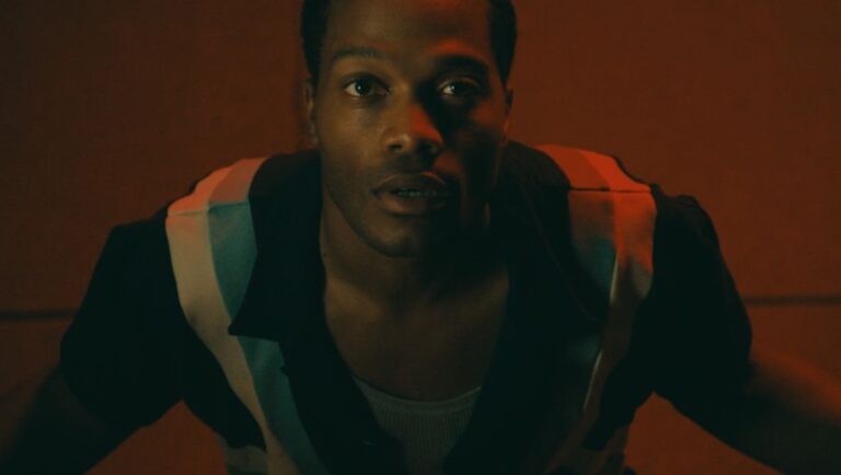 Terrestrial film still from Fantasia Festival 2025. Man looking up in red light.