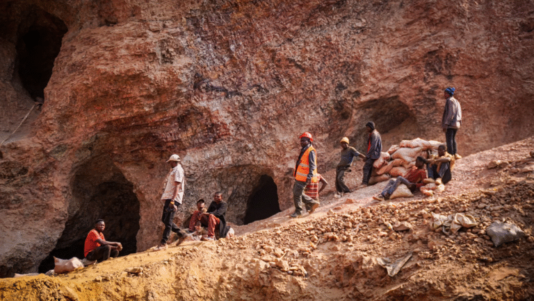 Film still from FIDMarseille 2025 Dispatch 3 featuring a coltan mine. Miners work near copper deposits. Headlights illuminate the Morlaix mine.