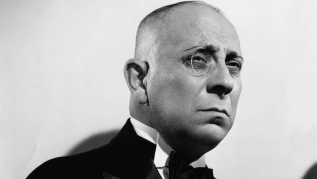 Erich von Stroheim, 20th Century actor, in black and white with a monocle. Classic Hollywood portrait.