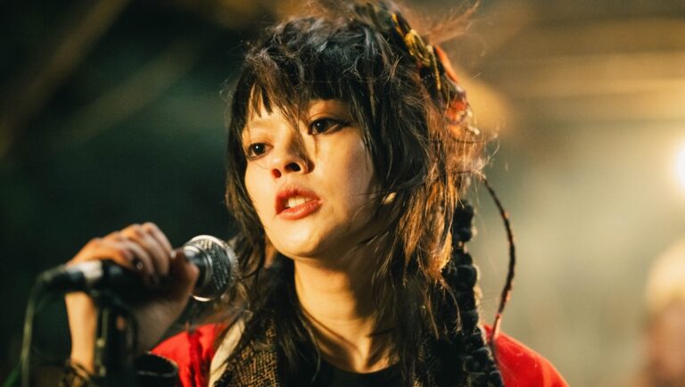 Asian female singer performs with a microphone. Concert, music, and entertainment.