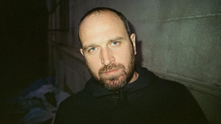 Alexandre Koberidze portrait. Man with beard, blue eyes, wearing black top. Copyright Irine Jorjadze.