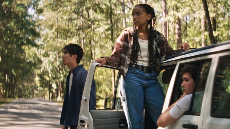 Three young adults on a road trip. Car parked on a wooded road. Teen drama.