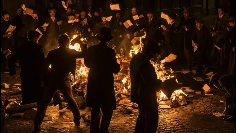 Book burning. A crowd of people throwing books into a bonfire at night. Censorship concept.