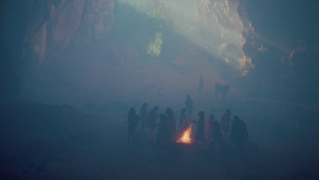 Mares Nest: People gather around a fire in a smoky cave. Ritualistic, dark, and mysterious.