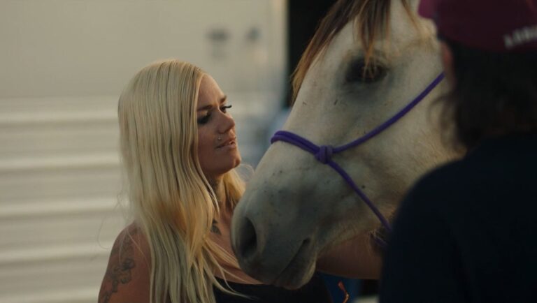 Woman with blonde hair petting her white horse. Equine love, horse riding, animal care.