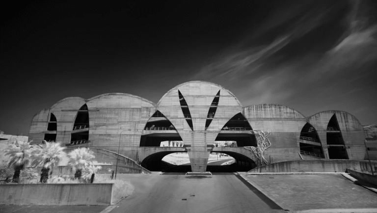 Black and white photo of Architecton building. Modern architecture with arches and unique design. Urban landscape.