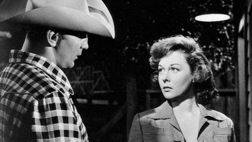 Black and white film still of a cowboy and woman. The Lusty Men, 1952.